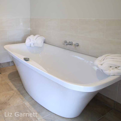 Professional property photograph of white bath by Liz Garnett