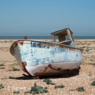 Old fishing boat on the shingle beach at Dungeness, Kent, by Liz Garnett